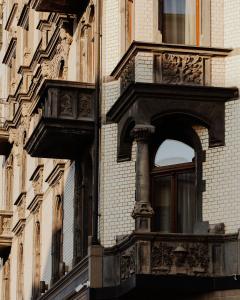 a building with a balcony on the side of it at Hotel Monopol in Katowice