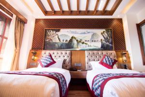 a hotel room with two beds and a painting on the wall at Everest Boutique Hotel in Kathmandu +37 photos