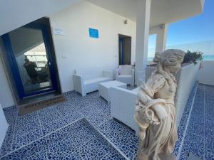 Una statua di una donna in una stanza con uno specchio di Salento Sottovento Luxury BeB a Torre Lapillo