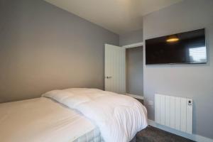 um quarto com uma cama e uma televisão de ecrã plano em Beautiful 4 Berth Seaside Apartment In Great Yarmouth, Norfolk Ref 99006s em Great Yarmouth