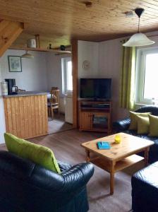 a living room with a couch and a coffee table at Zurück zur Natur... in Vollrathsruhe