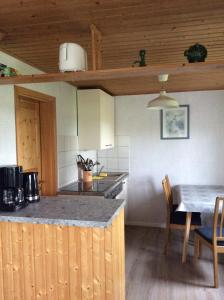 a kitchen with a table and a stove top oven at Zurück zur Natur... in Vollrathsruhe