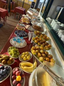a buffet line with many different types of food at Villa Adriana Hotel in Tivoli