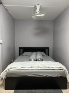 a bedroom with a large bed with a black headboard at Banana Muji Home-C6 F10-29 in Ban Song Hong