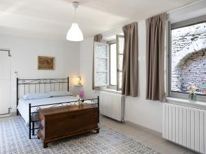a bedroom with a bed and a table in it at Casa Cecilia in Santo Stefano Belbo