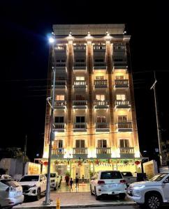 a large building with cars parked in front of it at LK Apartment & Hotel in Sihanoukville