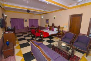 a hotel room with a bed and a checkerboard floor at Singrauli Palace Heritage Hotel in Saipur