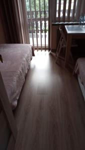 a bedroom with a bed and a desk and a window at Queens house in Oświęcim