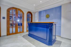 a large blue aquarium in a room with windows at Hotel Pavilion in Indore