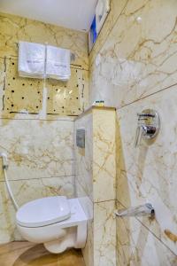 a bathroom with a toilet and a shower at Hotel Pavilion in Indore +35 photos