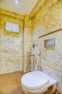 a bathroom with a white toilet in a room at Hotel Pavilion in Indore