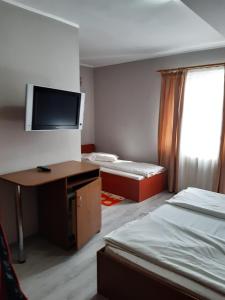 Postel nebo postele na pokoji v ubytování Pensiunea Tisa