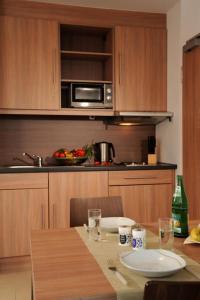 a kitchen with a table and a microwave at sleep in - Bielefeld Boardinghouse in Bielefeld