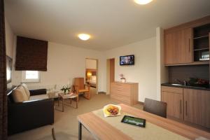 a living room with a kitchen and a dining room at sleep in - Bielefeld Boardinghouse in Bielefeld