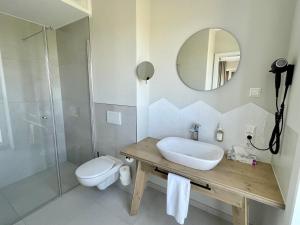 a bathroom with a sink and a toilet and a mirror at Westeroog in Wangerooge