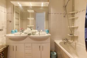 a bathroom with two sinks and a tub and a mirror at Oiseau de Feu in Villarembert +10 photos