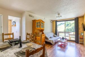 a living room with a table and a couch at Oiseau de Feu in Villarembert