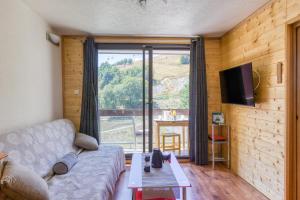 a living room with a couch and a table at Oiseau de Feu in Villarembert