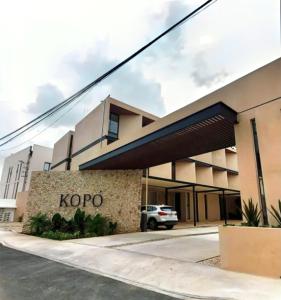 a kroop building with a car parked in front of it at New & beautiful apartment GF with private pool in Mérida