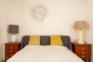 a bedroom with a bed with two night stands and two lamps at Lovely Beachfront Apartment with Panoramic Views in Altea