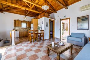 a living room with a couch and a table at Villa Chrysalis in Skopelos Town