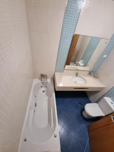 a bathroom with a tub and a sink and a toilet at Ocean pearl in Lagos +10 photos