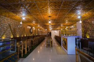 a dining room with tables and chairs and a ceiling at Hotel Haveli Palace in Ghaziabad