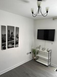 a living room with a flat screen tv on a wall at Remarkable 2-Bed Apartment in Wolverhampton in Wolverhampton