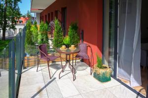 a patio with a table and chairs on a balcony at Quiet cozy apartment in Katowice +8 photos
