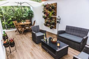 a patio with wicker furniture and a table and chairs at Casa Alivas in Furnas