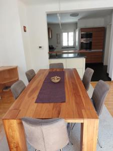 a dining room table with chairs and a kitchen at Country Residence near Vienna in Stillfried