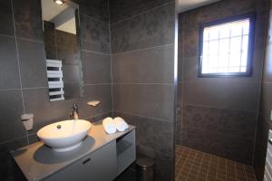 a bathroom with a sink and a mirror at Résidence Affasciata in Porto-Vecchio +31 photos