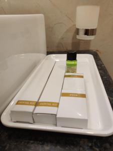 a white tray with a bottle of glue on it at Relax Inn in Bengaluru