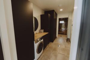 a laundry room with a washer and dryer at Villa Dyyni Yyteri - Sauna & Hot Tub - Near Beach in Pori +15 photos