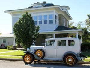 an old white car parked in front of a house at Sandstone Street Bed and Breakfast in Llano +18 photos