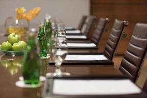 a long table with bottles and a bowl of apples at Four Seasons Hotel Riyadh in Riyadh