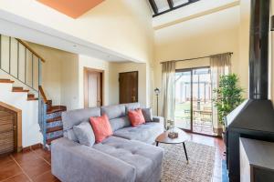 a living room with a couch and a fireplace at Casa Rural Sierramagna de 2 Dormitorios in El Ronquillo