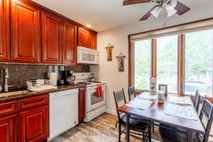 a kitchen with a table with chairs and a dining room at Redwood Retreat in Windham - minutes to Mtn! in Windham