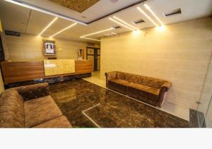 a waiting room with a couch and a table at Hotel Sundaram 5 Minutes Distance from Dargah in Ajmer +14 photos