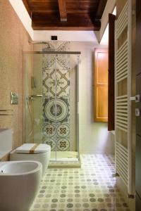 a bathroom with a shower and a toilet and a sink at Elda Hotel in Vico del Gargano