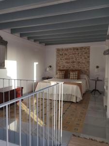 a bedroom with a bed and a brick wall at Ático Plaza 9 by casitasconencantoes in Medina Sidonia