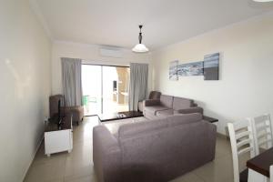 a living room with a couch and a tv at Saints View Resort Unit 23 in Uvongo Beach