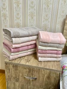 a stack of towels sitting on top of a dresser at Classic C1 Apartment In The Center With 4 Rooms in Tashkent