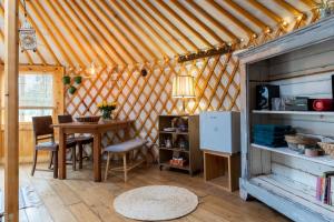 a dining room with a table in a yurt at YURs in Baexem