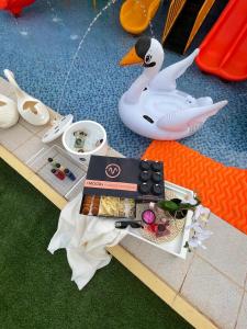 a table with a toy duck and a box of food at Chalet LV in Hafr Al Baten
