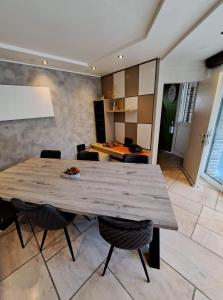 a dining room with a wooden table and chairs at Rêveries in Roeselare