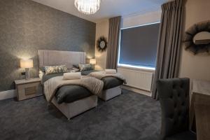 a bedroom with two beds and a window at The Fort Hotel in Dundee