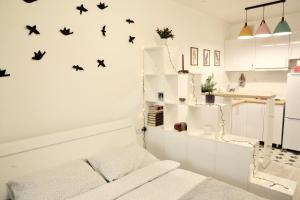 a white room with birds on the wall at ADT apartments in Almaty