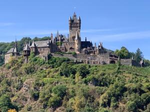 a castle on top of a hill at Ferienwohnung Moseltraum in Cochem