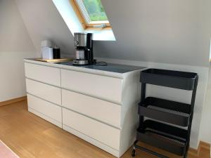 a white dresser with a coffee maker on top of it at Ferienwohnung Moseltraum in Cochem